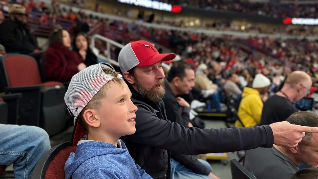 Kevin and his son at a Chicago Bulls game.