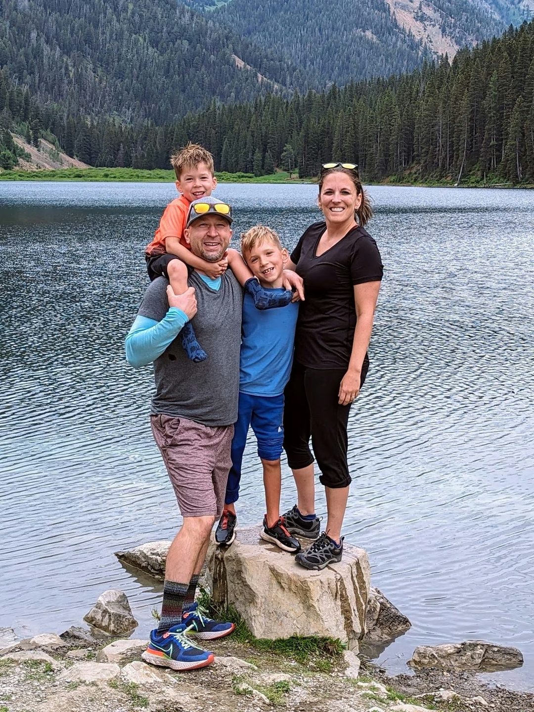 Kevin with Dr. Nicole Rodriguez and their sons at a mountain lake.