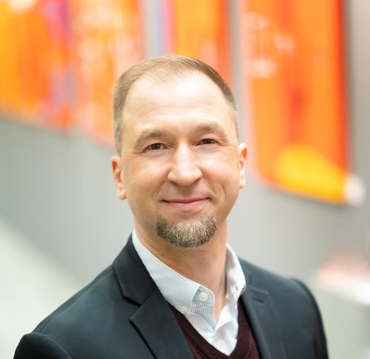 Headshot of Dr. Kevin Luczynski, dark jacket